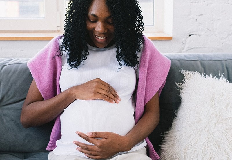 Black mother touching her future child