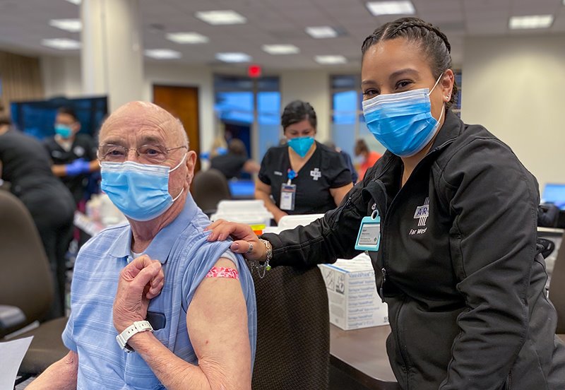 ARC nurse posing with elderly man after the covid-19 vaccine