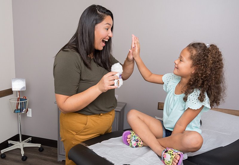 Pediatrician helping child learn about food