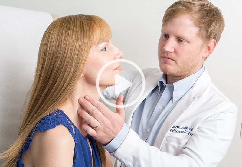 General Surgeon checking patient for thyroid disease